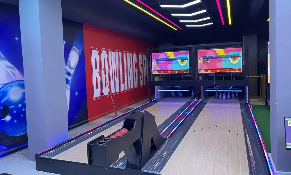 duckpin bowling alley with two lanes and screens showing scores